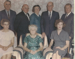 My grandmother and her seven children, my father at the upper left. Photos c 1960 Ludington Photo Studio.