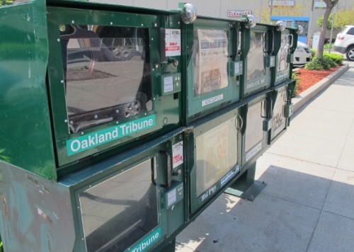 A newsrack in Oakland California showing papers by Bay Area News Group, which ran a story on May 10, 2015. It's an interview with Barbara Falconer Newhall, author, by Georgia Howe. Photo by Barbara Newhall