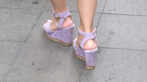 Super high -- feminine? -- wedge-heeled shoes worn by a woman in Shanghai. Photo by Barbara Newhall