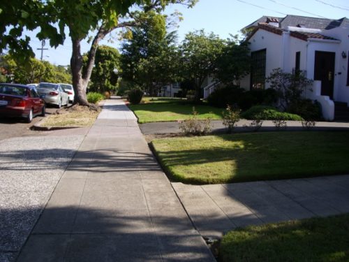 Wide sidewalks with houses visible from the street. Photo by BF Newhall
