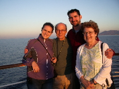 PHOTO TWO. The four of us a few minutes later in the glow of an Agean sunset.