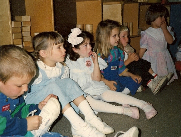 Preschool kids with hands on mouths & shoes. Photo by BF Newhall