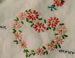 Mid 2oth century hand embroidered pillowcase with pink hearts. Photo by BF Newhall