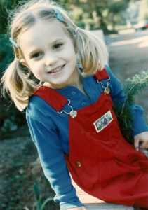 pretty 4-year-old girl in red overalls. photo by BF Newhall