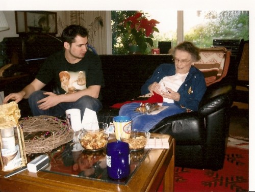 Young-man-&-his-grandmother-opening-Christmas-gifts. Photo by BF Newhall