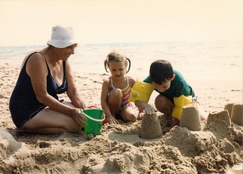 Small children with grandmother on Lake Michigan beach. Photo by BF Newhall.