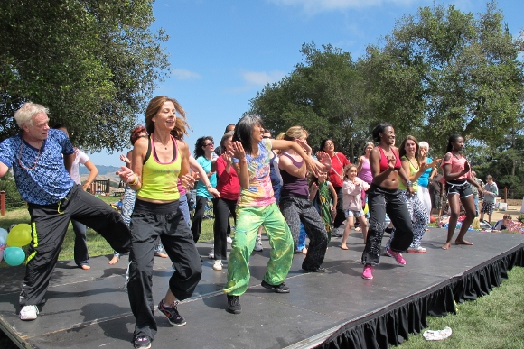 Zumba teachers lead a dance on stage at The Hills. Photo by Jon Newhall