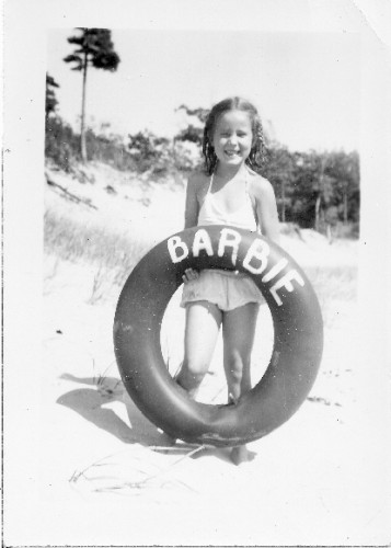 Barbara Falconer with inner tube on beach, MI. Photo by Tinka Falconer