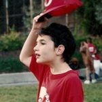 Peter Newhall lifts his Reds baseball cap during Piedmont CA rec department game. Photo 1991 by BF Newhall