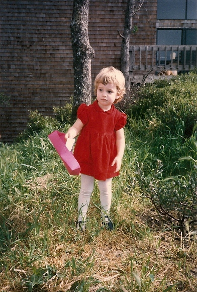 Three-year-old girl in a red dress looking forlorn. Photo by BF Newhall