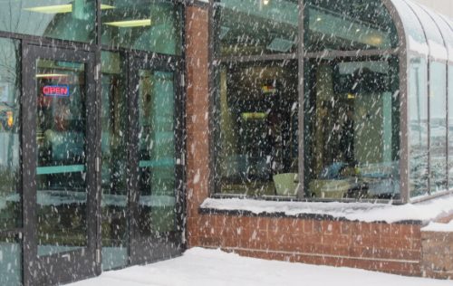 Fat snowflakes falling at the entrance to the Eden Prairie, MN, Community Center. Photo by BF Newhall.
