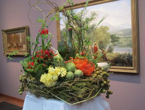Floral designer Dariel Alexander of Lafayette, CA, created a bucolic flower arrangement inspired by Jerome Thompson's 1857 painting of a picnic "Recreation"