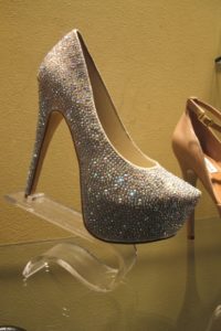 Deevaa shoes in 2013 display case at Steve Madden store, with very high heels and thick sole and gold glitter. Photo by BF Newhall