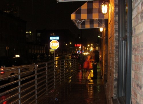 A young couple outside The Bachelor Farmer restaurant, Minneapolis, MN on a rainy night. Photo by BF Newhall