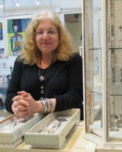 Jewelry artist Susan Brooks with jewelry cases in her Berkeley ca studio. PHoto by BF Newhall