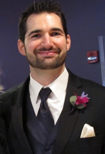 Handsome groom in tux, vest and tie with pink boutonniere before his wedding. Photo by BF Newhall