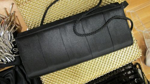  an evening handbag that's pretty and big. A long, narrow black satin evening bag at Macy's. Photo by BF Newhall