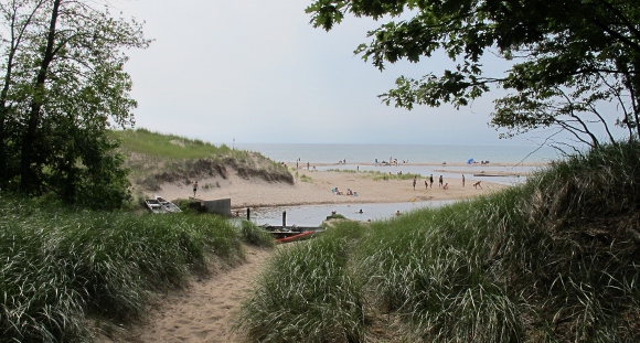 A channel leads through a sandy beach into Lake Michigan. Photo by BF Newhall