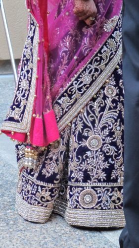 The bride wore a purple and cerise sari embroidered intricately with silver. Photo by BF Newhall
