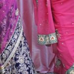 Bride in violet and cerise sari with guest in fuchsia sari at a wedding in San Francisco Bay Area. Photo by BF Newhall