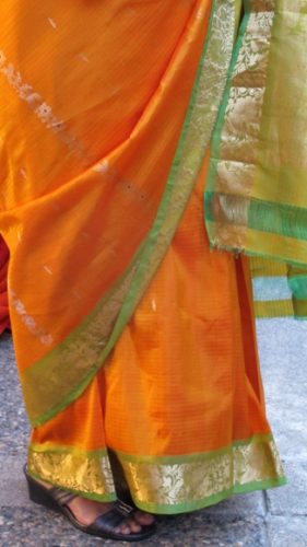 Orange silk sari with bright green border at an Indian wedding. Photo by BF Newhall