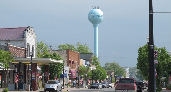 Hancock Street in downtown Pentwater, MI, village with water tower, shops and cars. Photo by BF Newhll