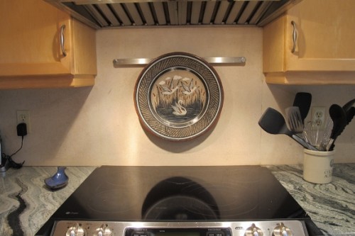 A stainless steel bar mounted over a ceramic cooktop holds a Tonala platter. Photo by BF Newhall