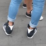 A Shanghai girls wears navy and white western-style sneakers with tight-fitting, cuffed jeans. Photo by BF Newhall
