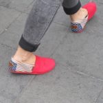 A Shanghai woman wears tight grey slacks showing ankles and red, white and blue espadrilles. PHoto by BF Newhall