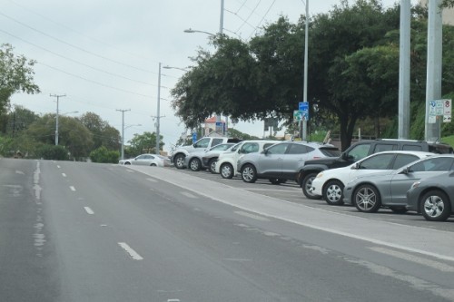 Cars parked on an angle facing out toward the street in Austin TX. Photo by BF Newhall