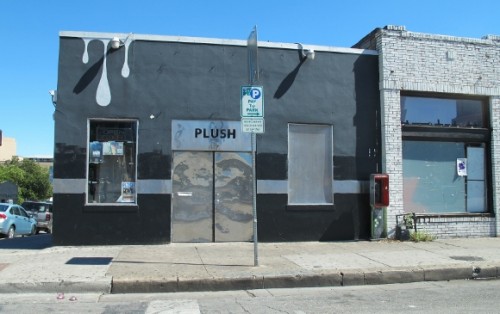 The Plush Dance Club in Austin TX has a sleek black and metallic storefront with silver drips painted over a windown. Photo by BF Newhall