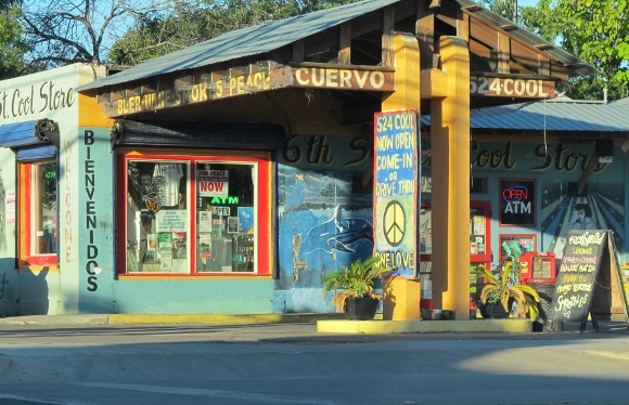 The sign over a gayly painted convenience store in East Austin, Texas, reads, "Beer, Wine, Smokes, Peace." Photo by bf newhall