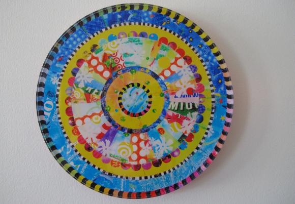 A round, mandala style work of art made from colorful plastic shopping bags by virginia fleck of austin tx. photo by bf newhall