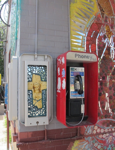 The face of Jesus painted on a cross on the door of a control box next to a pay phone at a check cashing establishment in Austin TX. Photo by bf newhall