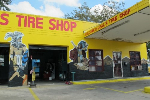 Leal's Tire Shop in Austin TX features yellow walls and murals of Montezuma. photo by bf newhall