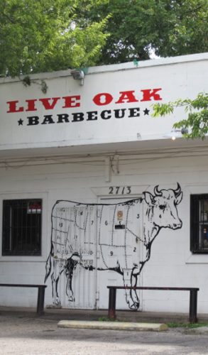 The facade of the Live Oak Barbecue restaurant in Austin TX features a diagram of a cow sectioned off for butchering. Photo by BF Newhall