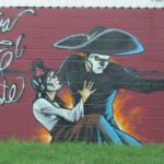A mural painted on a building in East Austin TX shows a man with sombrero and Spanish lady and the words, "Viva el Este." Photo by bf newhall