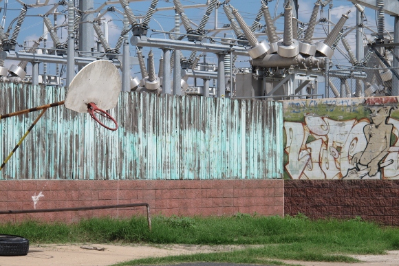 A power plant on Lady Bird Lake in Austin TX scheduled to be removed, with graffitti and a basketball net. Photo by BF Newhall