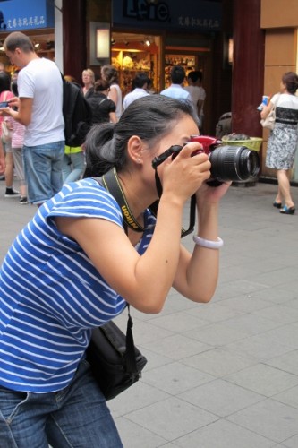 A woman in Shanghai aims her camera at her baby son. Photo by BF Newhall