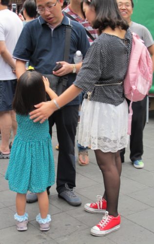 In Shanghai a mother and father look at their daughter in what could be a one-child family. Photo by BF Newhall
