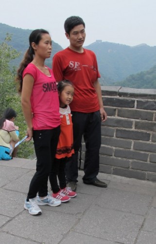 An Asian family that seems to be one-child gets its picture taken on the Great Wall of China. Photo by BF Newhall