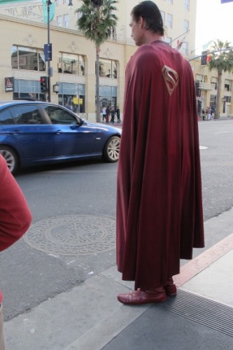 Actor Christopher Dennis on curb of Hollywood Boulevard dressed as Superman. Photo by BF Newhall