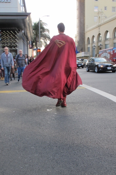 the superman at my house Actor Christopher Dennis dressed as Superman crosses Holllywood street cape billowing. Photo by BF Newhall