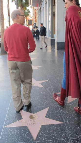 Actor Christopher Dennis in Superman outfit strolls along the Hollywood Walk of Fame with Jon Newhall. Photo by BF Newhall