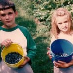 Two children show off the buckets of blueberries they've picked in Michigan. Photo by BF Newhall