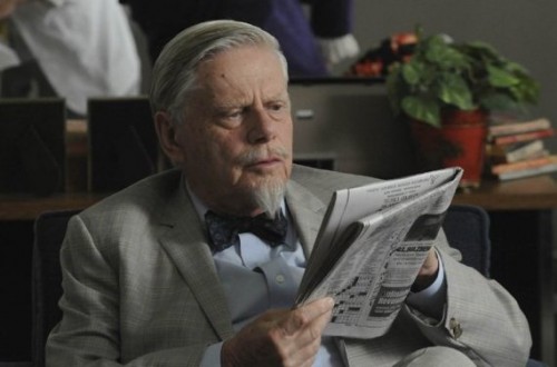 Actor Robert Morse reading newspaper as Bert Cooper in the Mad Men TV series