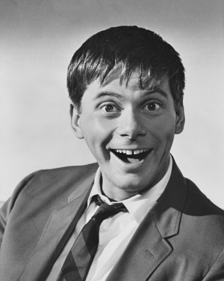 A black and white photo of actor Robert Morse as a young comedian gawking for the camera.