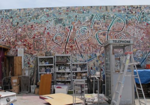 Cluttered courtyard of Jingletown Art Studios, Oakland, CA. Mosaic mural by Philadelphia artist Isaiah Zagar. Photo by BF Newhall