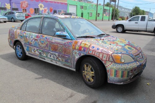a car entirely covered with mosaics parked in Oakland, CA, Jingletown neighborhood. Photo by BF Newhall