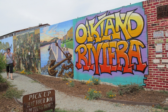 First panel of the murals along Rue de Merde in Jingletown, an Oakland, CA, neighborhood is by Bill Silveira. It shows the words "Oakland Riviera." Photo by BF Newhall